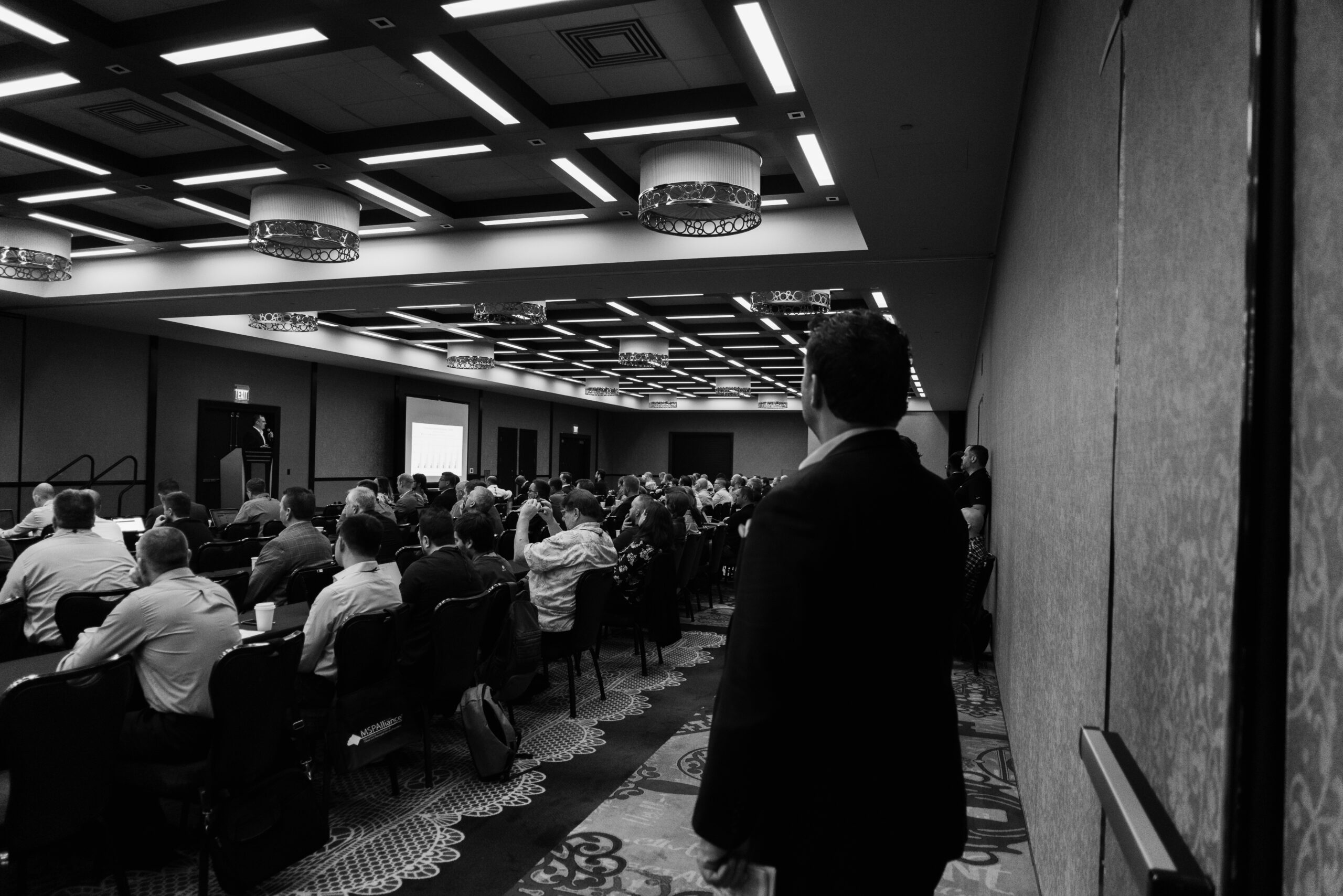 Pierre Rogers speaking to a packed room